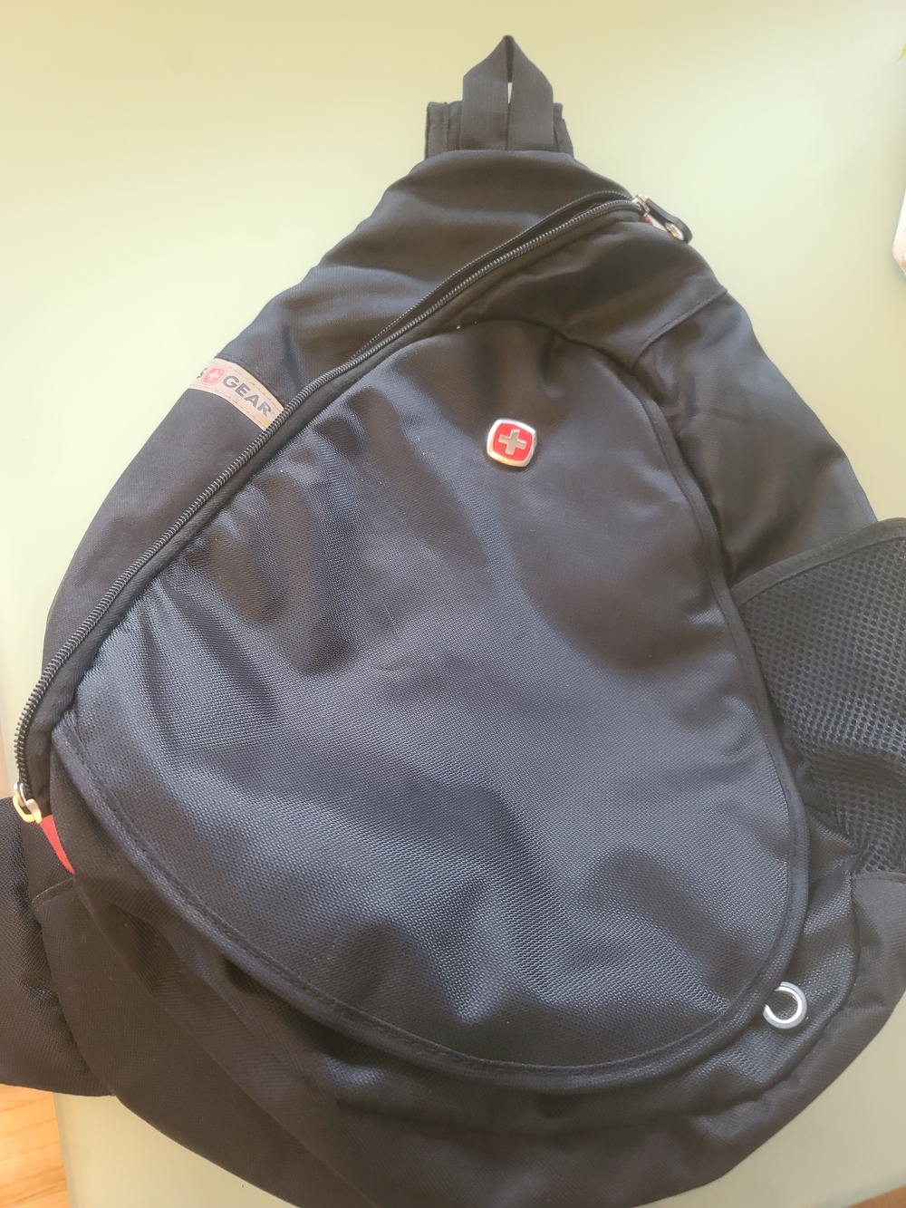 SwissGear Black Single-Shoulder Sling Backpack with Red Emblem